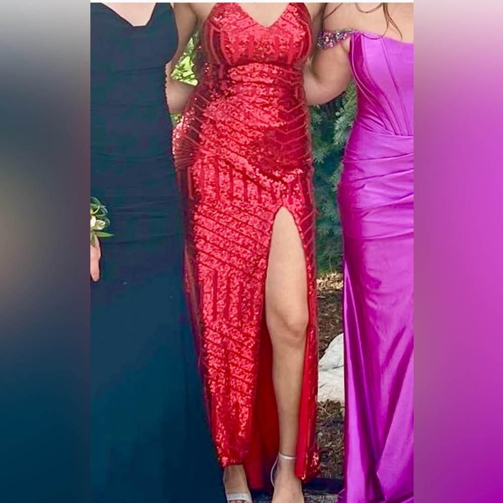Red sequin formal, form fitting but has stretch. Sparkle day and night.